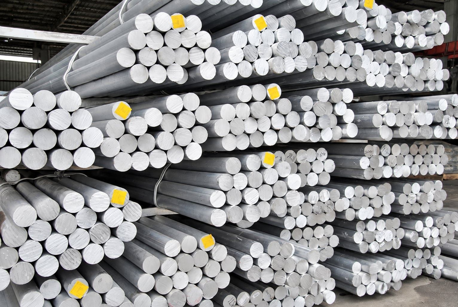 Close-up of cast aluminum extrusion billets stacked for the presses